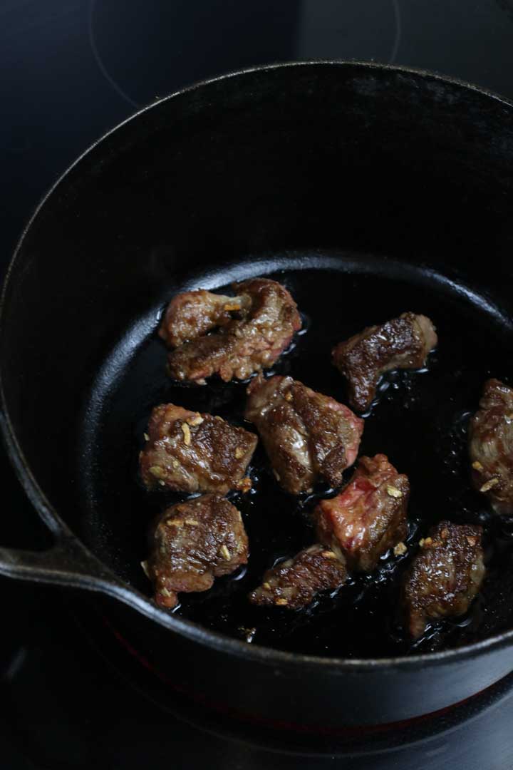 Beef browned in a cast iron pot