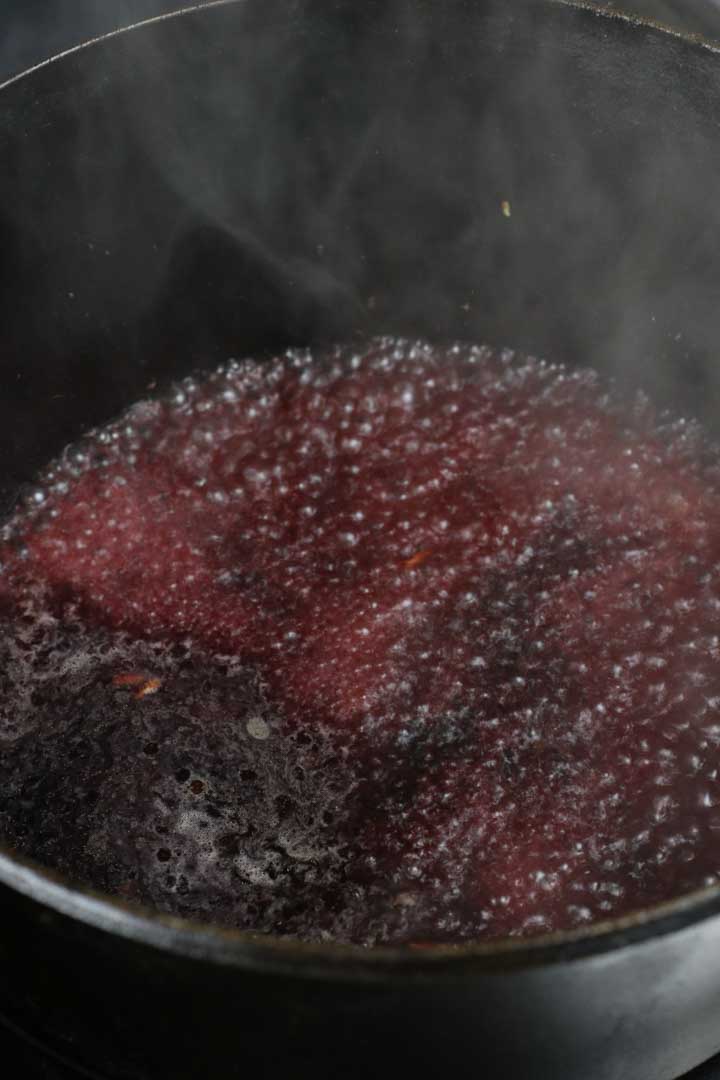 Red wine de glazing in the pot