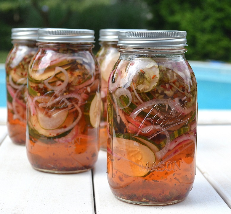 Sweet and Spicy Pickled Cucumbers in jars. Easy quick pickle recipe