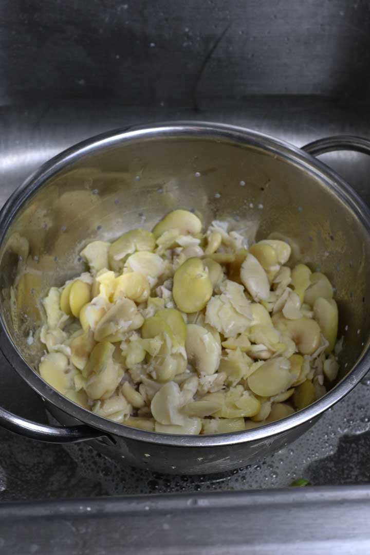 Drained and rinsed fava beans in a colander