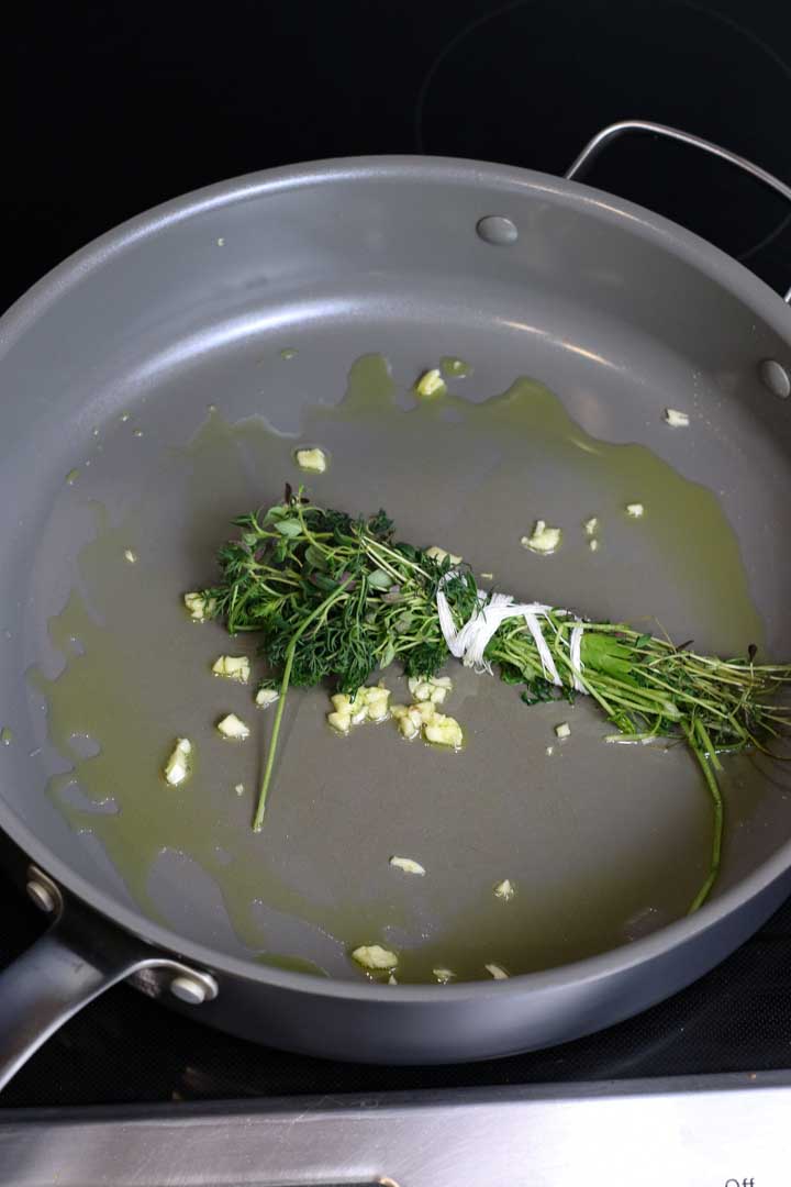 Fresh herbs, garlic, and olive oil on medium heat.
