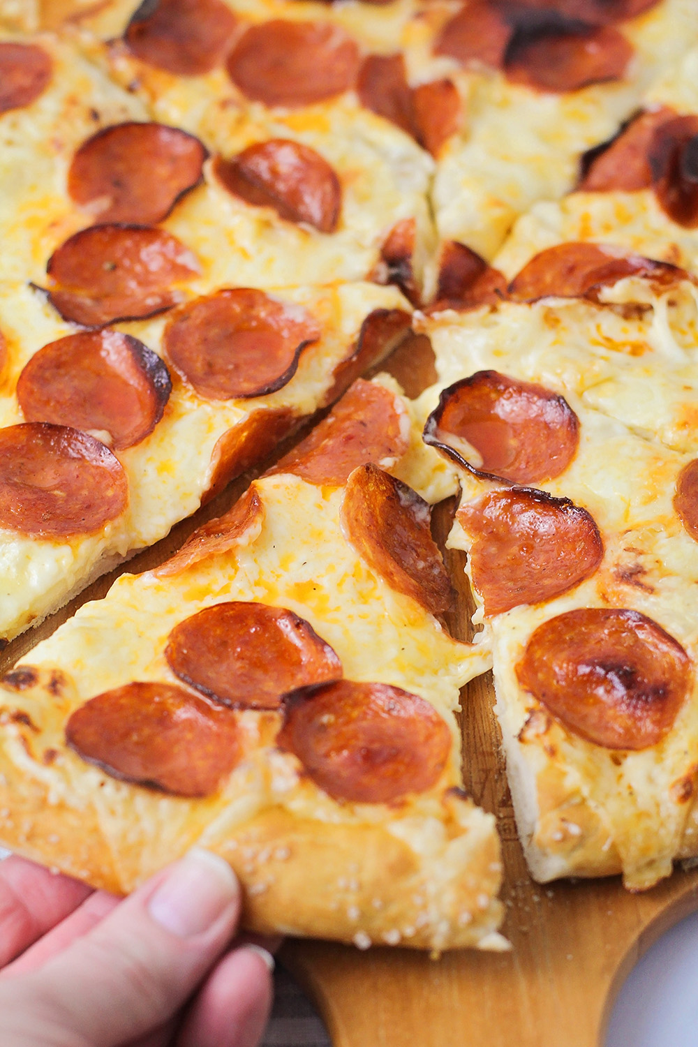 This copycat pretzel crust pizza is better than store-bought and totally delicious! It's so easy and fun to make at home!