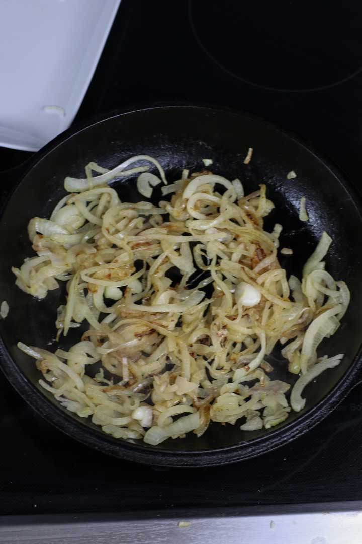 Browning onions in a pan.