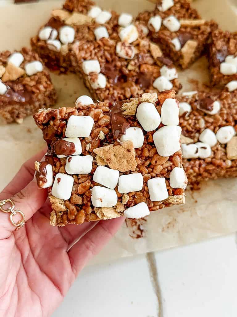 a hand holding one of the s'mores rice krispie treats
